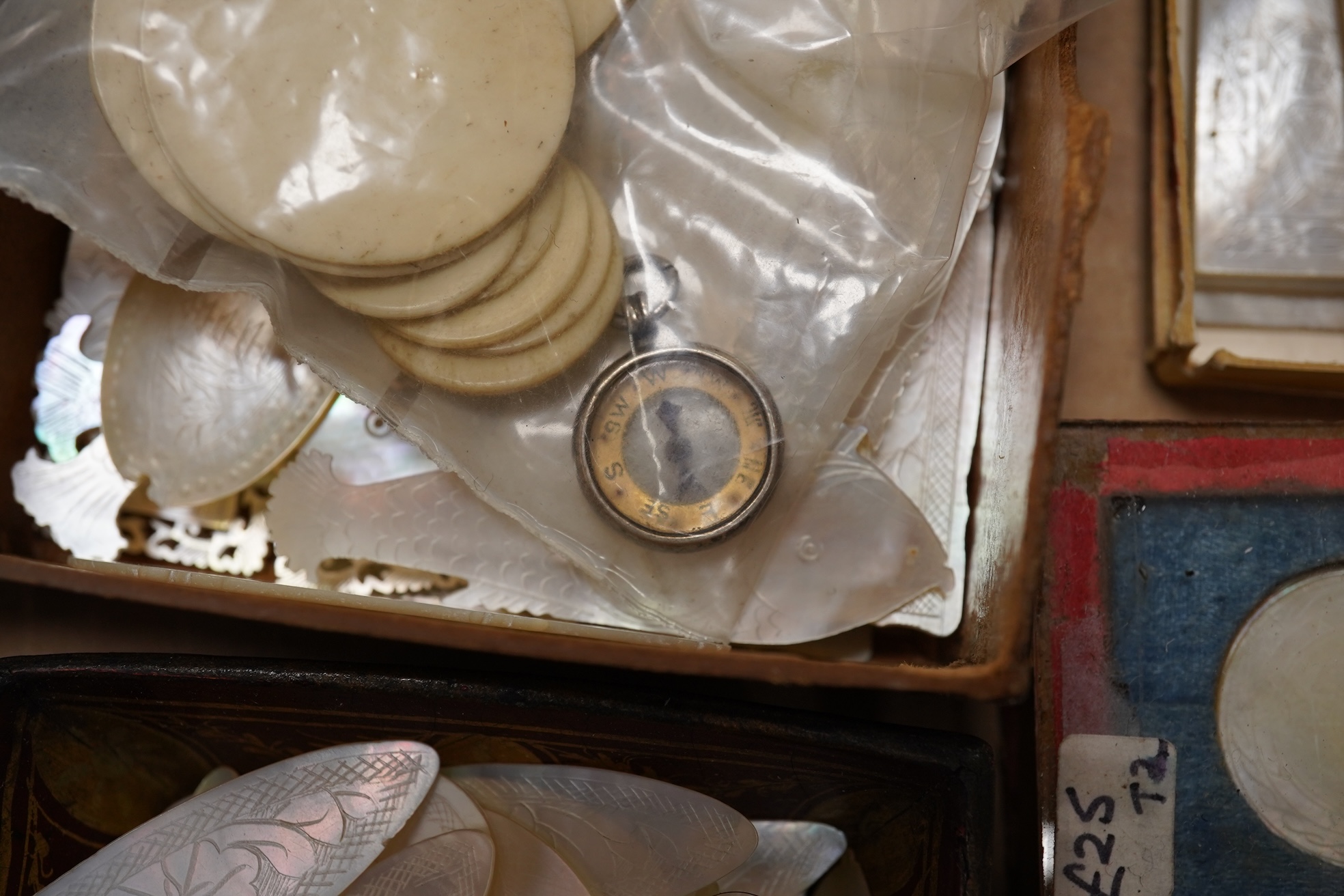 A group of 19th century Chinese mother of pearl gaming counters and accessories, together with a miniature silver cased compass